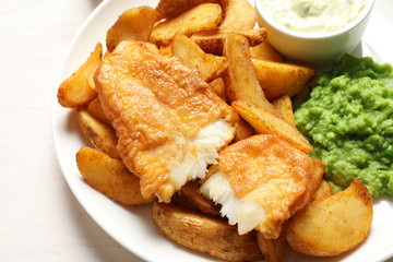 British Traditional Fish and potato chips on table, closeup