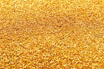 Texture of gold glitter as background, closeup