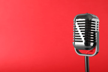 Retro microphone on color background, space for text