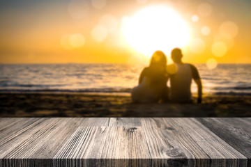 Love couple kissing on tropical beach in sunset. Holiday background. Empty table top for product display montage.