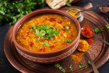 Indian dal. Traditional Indian soup lentils.  Indian Dhal spicy curry in bowl, spices, herbs,...