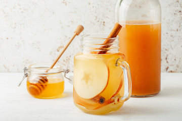 Cool, healthy drink with apple cider vinegar, honey, apples and cinnamon