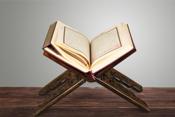 Islamic Book Koran with rosary on background