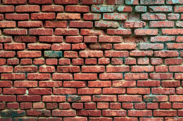 Background from an old brick wall with red bricks with a shabby texture