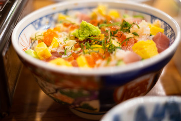 Chirashizushi big bowl of rice mixed with fish and vegetables.