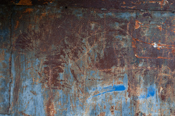 Horizontal background of old rusty burnt iron with peeling paint