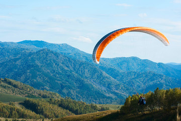 Paragliding in Altai mountains. Paragliders in fight in the mountains, concept of extreme sport activity.