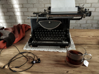 Workplace old school writer with tea and typewriter