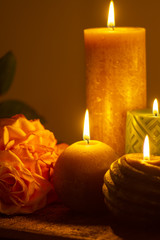 Six burning candles and roses, warm colors, feelings and memory, soft warm colors close up