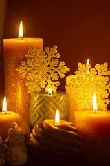 Dark key Christmas decoration, soft cosy candlelight and snowflakes close up copy space
