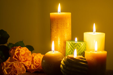 Six burning candles and roses, warm colors, feelings and memory, soft warm colors close up