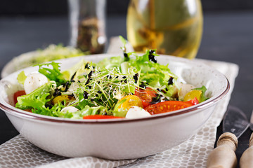 Vegetarian salad with cherry tomato, mozzarella and lettuce. Italian cuisine.
