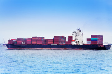 Ship full loaded with containers against blue sky