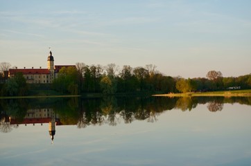 Reflection of Nesvizh Castle in the pond in autumn. Nyasvizh, Nieśwież, Nesvizh, Niasvizh, Nesvyzhius, Nieświeżh, in Minsk Region, Belarus. Site of residential castle of the Radziwill family. 