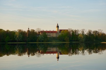 Reflection of Nesvizh Castle in the pond in autumn. Nyasvizh, Nieśwież, Nesvizh, Niasvizh, Nesvyzhius, Nieświeżh, in Minsk Region, Belarus. Site of residential castle of the Radziwill family. 