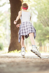 Young woman with inline skates in park