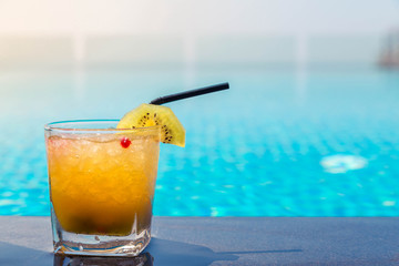Yellow cocktail near the swimming pool