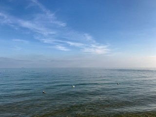 Obraz premium blue sky above the sea with clouds and sun in Greece