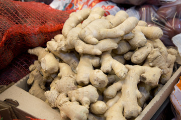 Fresh ginger on the market. Close-up. Oriental spices. Ginger in the vegetable street market. Ginger in the supermarket. Ginger background. Street vegetable market.