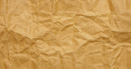 Crumpled brown paper sheet background with texture
