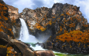 Fototapeta na wymiar Autumn view of Kurkure waterfall in the mountains of Altai region, Siberia, Russia