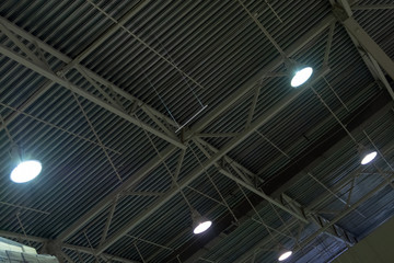 Ceiling storage area with bright lamps. Abstract background. Metal roof hangar.