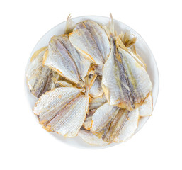 Dried fish in a round plate isolated on white