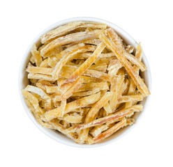 Dried fish in a round plate isolated on white