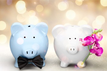 White and blue piggy banks on table on background
