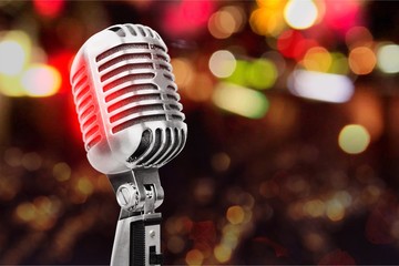 Retro style microphone on bokeh background, music recording.