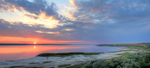 summer landscape on the banks of the  lake at sunset at Ukraine