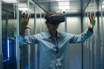 Technician works in a data center wearing a VR headset
