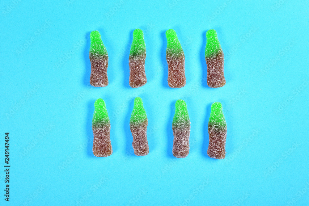 Wall mural group of jelly candies coke bottles on blue background