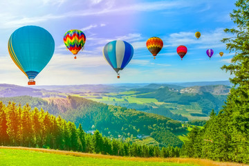 Obraz premium Hot air balloon flying over amazing mountains