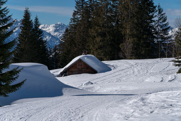 Fototapeta na wymiar Hütte in den Bergen versinkt in Schneemassen