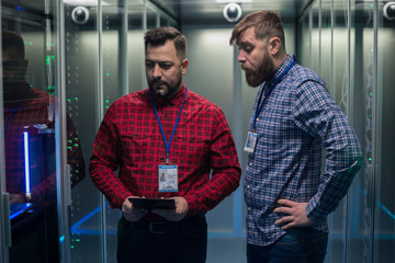 Diverse coworkers walking in server room