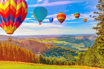 Hot air balloon flying over amazing mountains