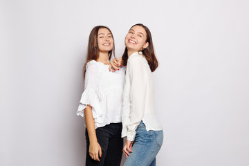 two laughing girls in white blank t-shirts looking into the camera