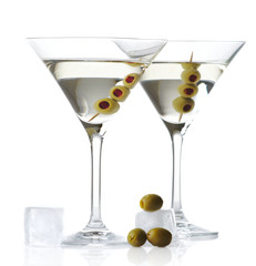 Two classic dry martini with olives and ice cubes isolated on white