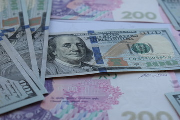 American one hundred dollars banknote and ukrainian hryvnas