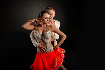 Couple dancing, elegant man and woman in studio