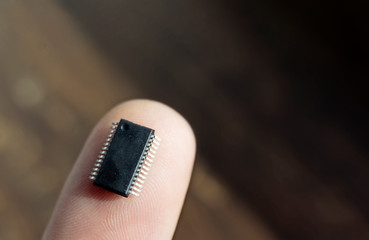 Microchip on a finger, microchip pins match the lines of the fingerprint, concept, bio-integrated...