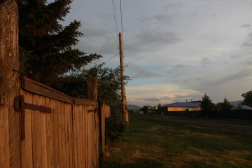 old wooden fence close-up on the background of a rural landscape