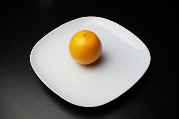  isolated orange on white plate on black