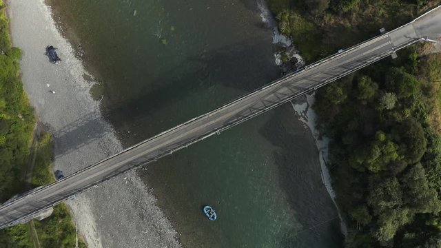 Aerial rise, rafting down Rangitikei river under old fashioned bridge, New Zealand