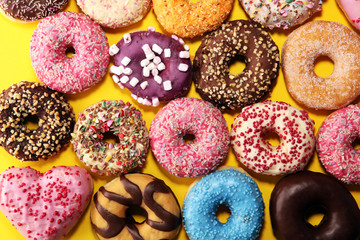 assorted donuts with chocolate frosted, pink glazed and sprinkles donuts