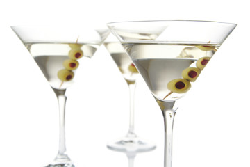 Close-up three classic dry martini with olives isolated on white