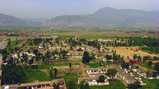 Peshawar, Pakistan, Aerial view of busy mountain pass connecting the Pak-Afghan border through white range with valley of Peshawar
