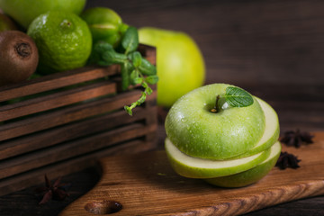 Fototapeta na wymiar Set of green fruits for healthy diet and detox: apple, lime, kiwi, mango, carambola and mint.