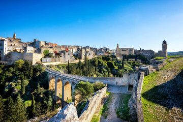 Fototapeta na wymiar Gravina in Puglia, with the Roman two-level bridge that extends over the canyon. Apulia, Italy.